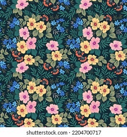 Beautiful floral pattern in small abstract flowers. Small colorful flowers. Dark blue background. Ditsy print. Floral seamless background. The elegant the template for fashion prints. Stock pattern.