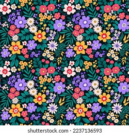 Beautiful floral pattern in small flowers. Small colorful flowers. Black background. Ditsy print. Floral seamless background. The elegant the template for fashion prints. Stock pattern.