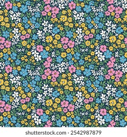 Beautiful floral pattern in small flowers. Small multicolor flowers. Dark blue background. Ditsy print. Floral seamless background. Cute template for fashion prints. Stock pattern.