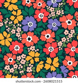 Beautiful floral pattern in small trendy flowers. Small colorful bright flowers. Dark blue background. Ditsy print. Floral seamless background. Liberty template for fashion prints. Stock pattern.