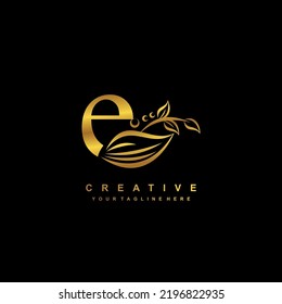 beautiful flourish gold letter E logo design. initial letter E. monogram, typography E. E luxurious logo with floral and leaf ornament. useful for company logo, business, boutique, wedding, brand, etc