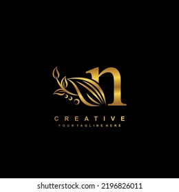 Beautiful Flourish Gold Letter N Logo Design. Initial Letter N. Monogram, Typography N. N Luxurious Logo With Floral And Leaf Ornament. Useful For Company Logo, Business, Boutique, Wedding, Brand, Etc