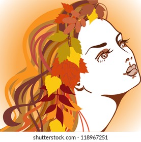 beautiful girl with autumn leaves in long hair