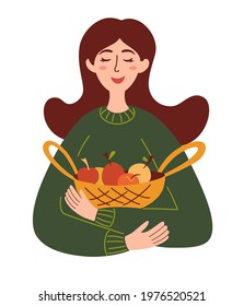 Beautiful girl with a basket of apples. Harvest season, healthy food, concept farm products. Girl farmer holds fruits in a basket.  Vector illustration in cartoon flat style.