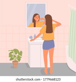 Beautiful girl brushing her teeth in front of the bathroom mirror. Morning routines of self-care, dental health. Flat cartoon vector illustration.