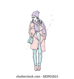 Beautiful girl in a coat with a cap and a scarf. Stylishly dressed woman. Vector fashion illustration.
