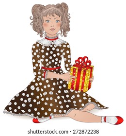beautiful girl with curly hair in festive dress with a gift