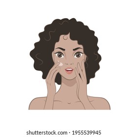 A beautiful girl with dark curly hair applies a moisturizer to her face. Skin care