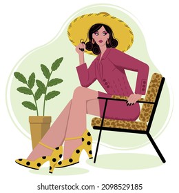 A beautiful girl in a flap sits in a chair. Vector flat illustration