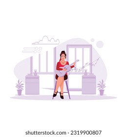 A beautiful girl in glasses sits on a chair and sings while playing the guitar. Trend Modern vector flat illustration.