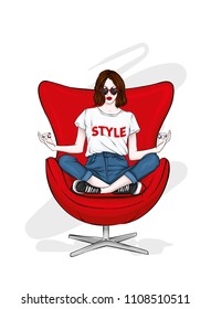 A beautiful girl in jeans and a stylish top is sitting in a stylish chair in a yoga pose. Vector illustration. Clothes and accessories. Print on clothes. Fashion & Style. Fashionable look.