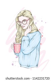 A beautiful girl with long hair in glasses and a warm sweater. Girl with a cup of coffee or tea. Vector illustration for a postcard or a poster, print for clothes. Fashion & Style.