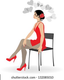 The beautiful girl in a short red dress and stockings sits on a chair