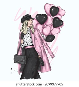 Beautiful girl in stylish clothes and balloons in the form of hearts. Valentine's Day and Love.