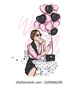 Beautiful girl in stylish clothes and balloons in the form of hearts. Valentine's Day and Love.