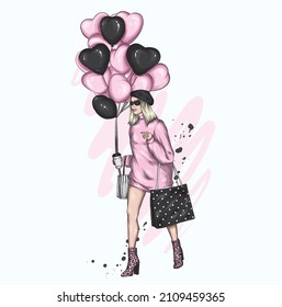 Beautiful girl in stylish clothes and balloons in the form of hearts. Valentine's Day and Love.