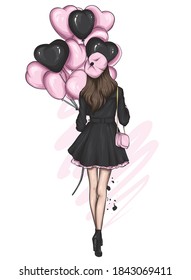 A beautiful girl in a stylish coat. Fashionable clothes and accessories, fashion and style. Heart shaped balloons. Valentine's Day.