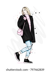 Beautiful girl in a stylish coat, jeans and shoes. Vector illustration for a postcard or a poster. Fashion and style, clothing and accessories.
