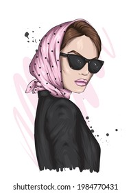 A beautiful girl in a stylish headscarf and glasses. Fashion and style, clothing and accessories.