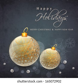 Beautiful golden Xmas balls on grey background, Happy Holidays concept. 