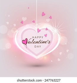 Beautiful greeting card design with hanging heart on shiny pink background for Happy Valentines Day celebration.