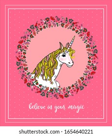 Beautiful greeting card with white unicorn embraced with floral wreath with lettering believe in your magic isolated on the pink background. Vector illustration for cards,  invitations, decoration
