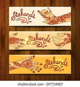 Beautiful hand drawn banners mehendi on women's hands