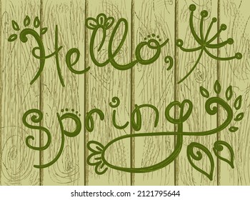 Beautiful handmade vector lettering hello spring written in green on the background of an old vintage board fence. Positive wallpapers with grass and deciduous patterns and a joyful spring greeting.