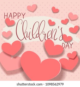 Beautiful handwritten brush lettering vector illustration Happy Children's Day with paper cut hearts decorations on polka dot background.