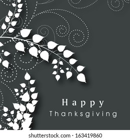 Beautiful Happy Thanksgiving Day celebration poster, banner or flyer with leaves and floral designs on grey background. 