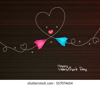 Beautiful Happy Valentine's Day wooden background with colorful paper planes, made Heart shape trail.