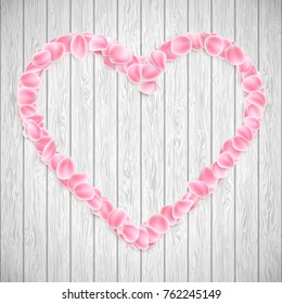 Beautiful heart made from pink Sakura petals on wooden texture. And also includes EPS 10 vector