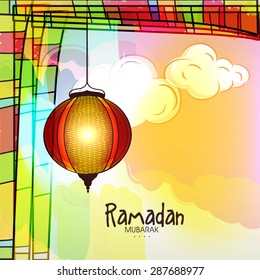 Beautiful illuminated hanging Arabic lantern on abstract colorful background for holy month of Muslim community, Ramadan Kareem celebration. 