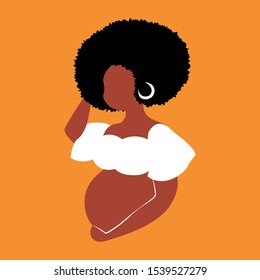 Beautiful image of african pregnant woman with brown skin and big hair holding her belly