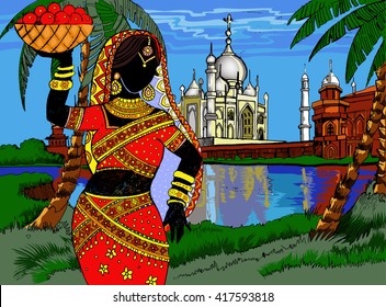 Beautiful Indian woman on the background of the Indian landscape with Taj Mahal