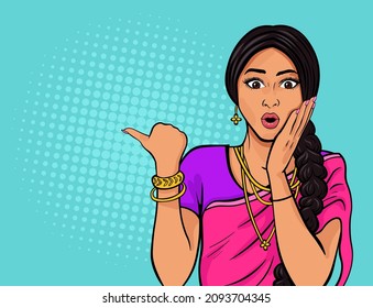 Beautiful indian woman in wearing traditional indian clothing sari expressing amazement and pointing