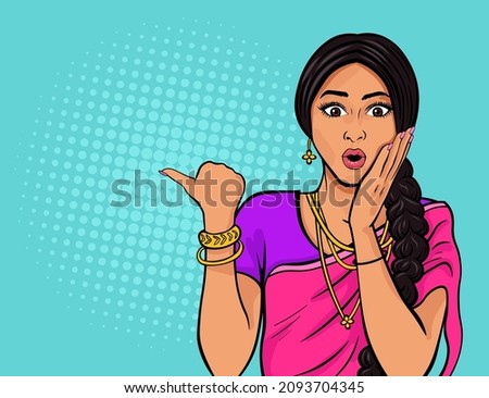 Beautiful indian woman in wearing traditional indian clothing sari expressing amazement and pointing