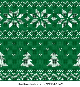 Beautiful knitted green jacquard seamless pattern with white flowers and Christmas tree. Vector illustration.