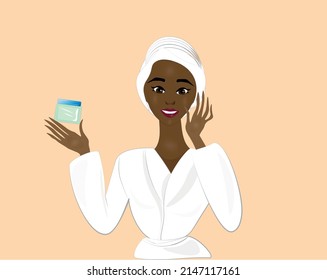 beautiful lady with face cream in her hand. Charming Lady after a shower in a bathrobe, applies cream on her face and neck. Skin glows with youthfulness and health.