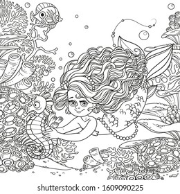 Beautiful little mermaid girl swimming with sea horse in the hands on underwater world with corals, anemones and fish background