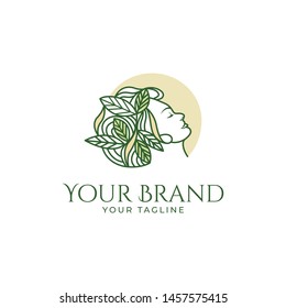 beautiful logo template of woman's face with leaf and organic hair isolated in a circle
