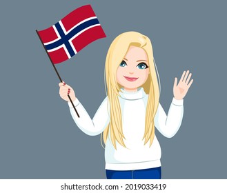 Beautiful long haired blonde Norwegian woman waving Norway flag and saluting with hand