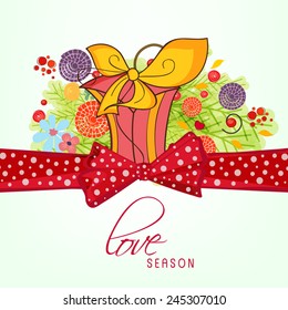 Beautiful love card design with gift box and red ribbon on flowers decorated background.