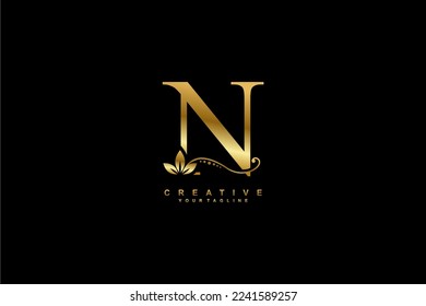 
beautiful luxury logo design initial golden letter N with gorgeous flourish ornament. monogram typography letter N with gold leaf and floral ornament decoration