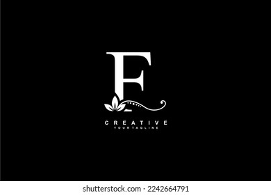 beautiful luxury logo design initial white letter F with gorgeous flourish ornament. monogram typography letter F with gold leaf and floral ornament decoration