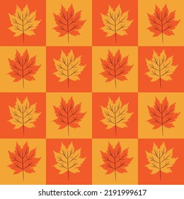 Beautiful maple leaves on orange and yellow checkerboards seamless pattern .For autumn and Thanksgiving posters, fabric , textile and wrapping paper