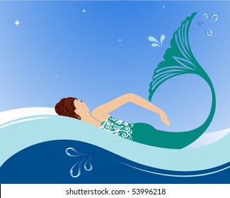 Beautiful mermaid swimming in ocean