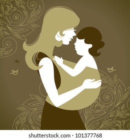 Beautiful mother silhouette with baby in a sling