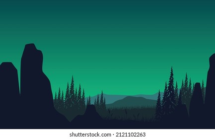 Beautiful mountain view from the edge of the cliff with the silhouette of the pine trees around it