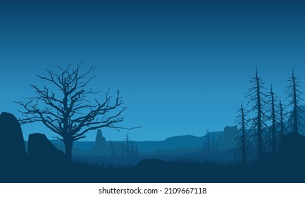 Beautiful mountain view at night with fantastic silhouettes of dry trees around it